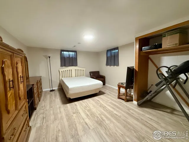 a bedroom with a bed a mirror and desk