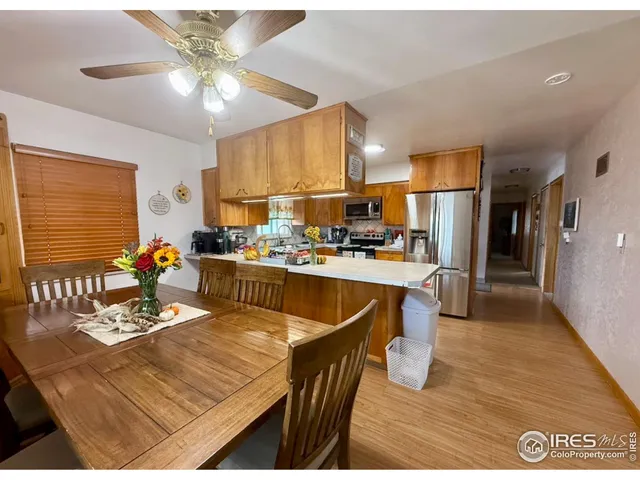 a room with stainless steel appliances kitchen island granite countertop furniture and a kitchen view
