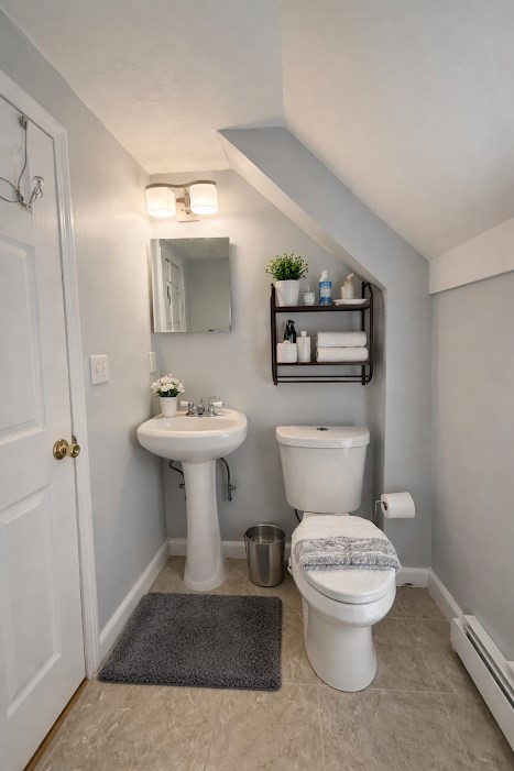 130 Elm Street, Unit 2 Marlborough, MA 01752 - Photo 4 of 6 a bathroom with a toilet sink and mirror