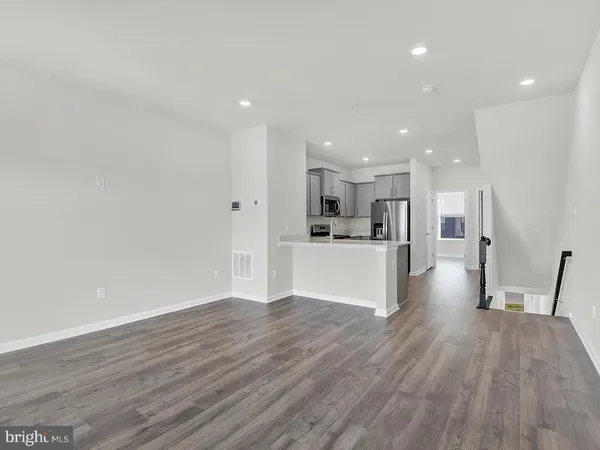 a kitchen with stainless steel appliances granite countertop a stove a refrigerator and a sink