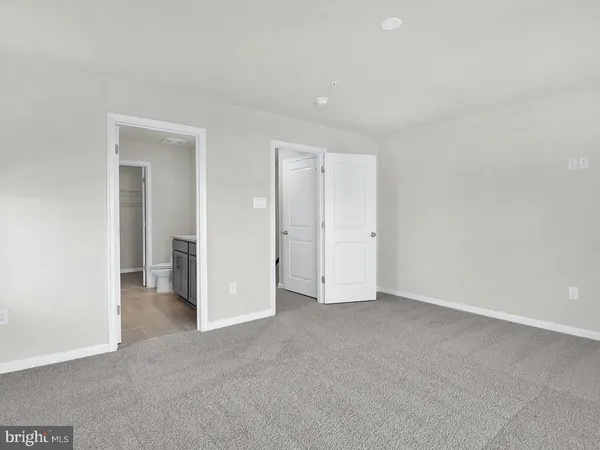 a bathroom with a granite countertop bathtub shower sink vanity mirror and toilet