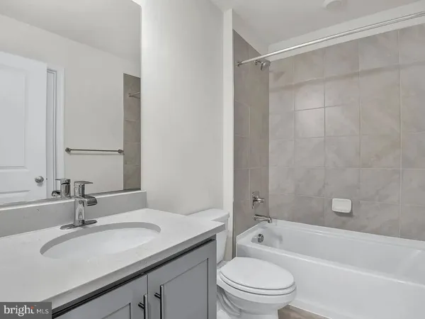 a view of a bathroom with cabinet and mirror