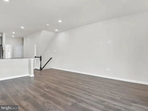 a view of kitchen dining table wooden floor and kitchen