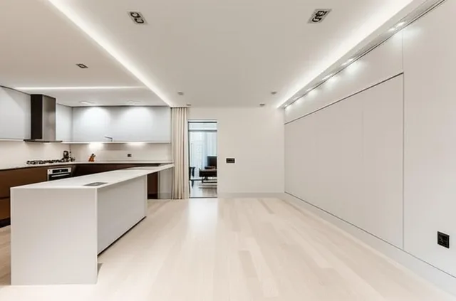 a view of kitchen with furniture and a refrigerator
