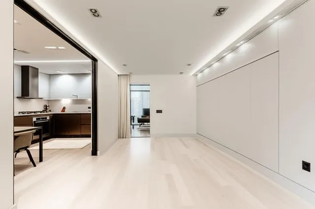 a kitchen with stainless steel appliances granite countertop a stove a sink dishwasher and cabinets with wooden floor