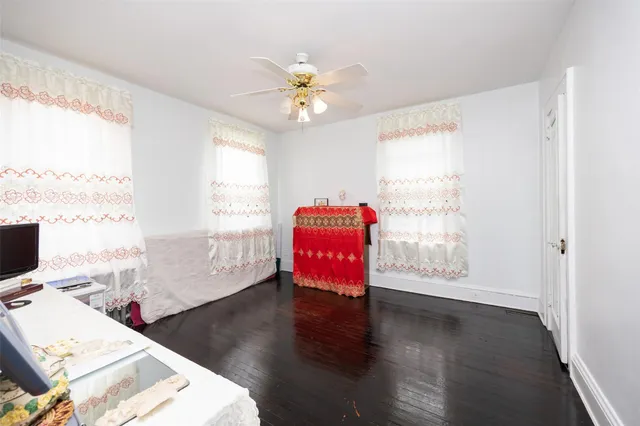 a room with a wooden floor and white walls