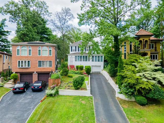 an aerial view of residential houses with outdoor space and street view