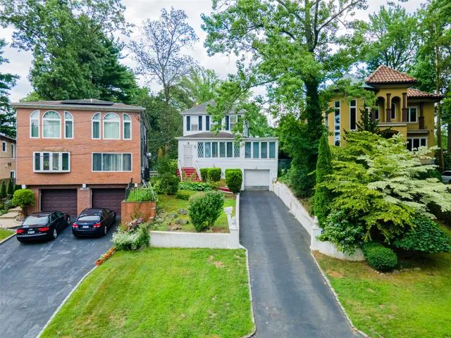 a front view of a house with a garden and pathway