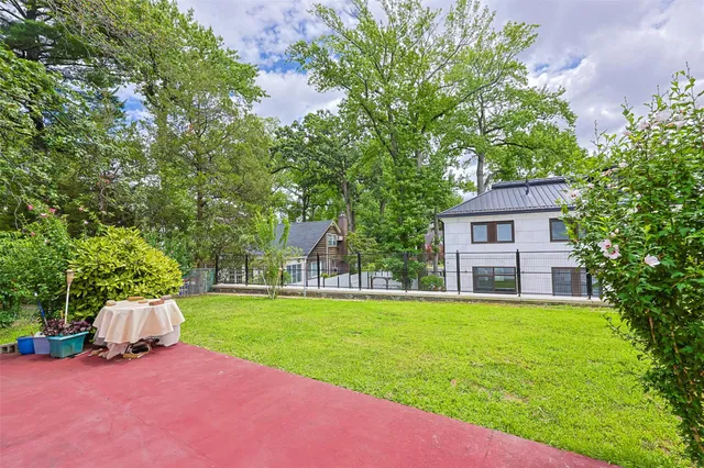 a view of a house with a yard and a patio