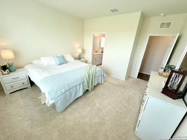 a bedroom with a bed a window and dresser