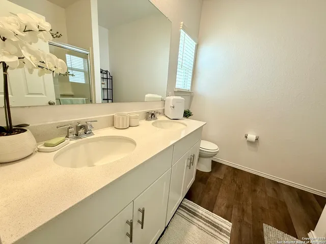 a bathroom with a toilet a sink and a mirror