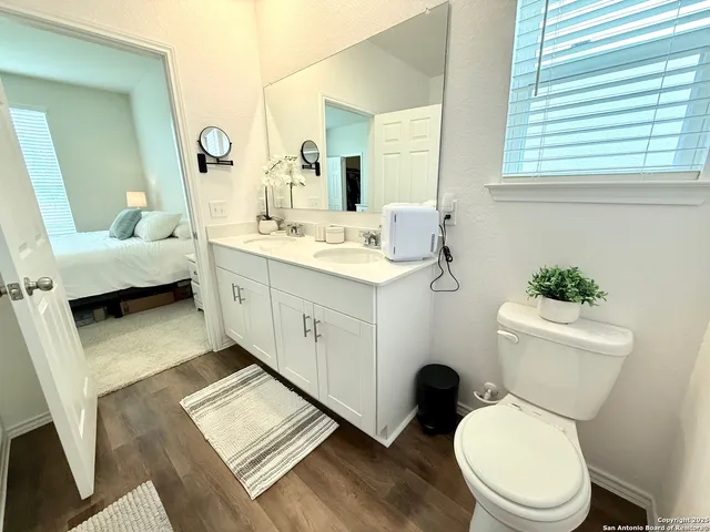 a bathroom with a glass shower door and a mirror