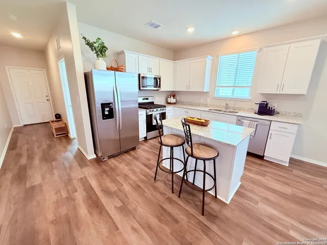 a stove top oven sitting inside of a kitchen