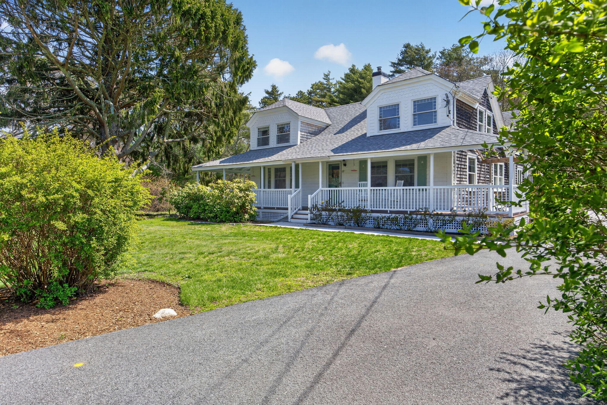 69 County Road Bourne, MA 02532 - Photo 41 of 54 a front view of a house with a yard and potted plants