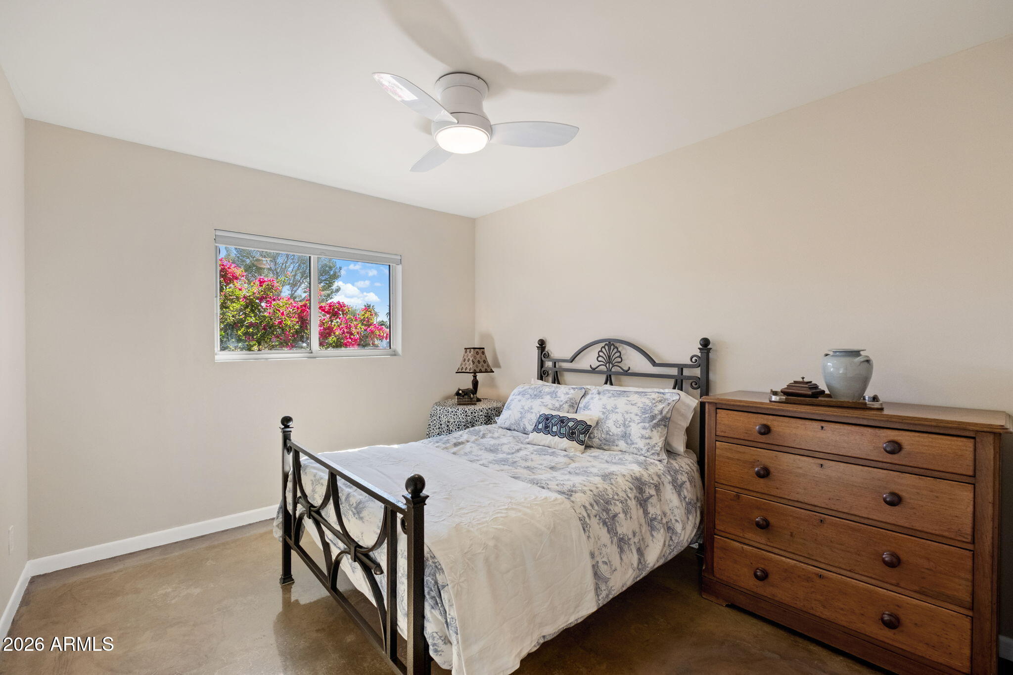 4901 North 82nd Street Scottsdale, AZ 85251 - Photo 26 of 48 a bedroom with a bed and a chandelier