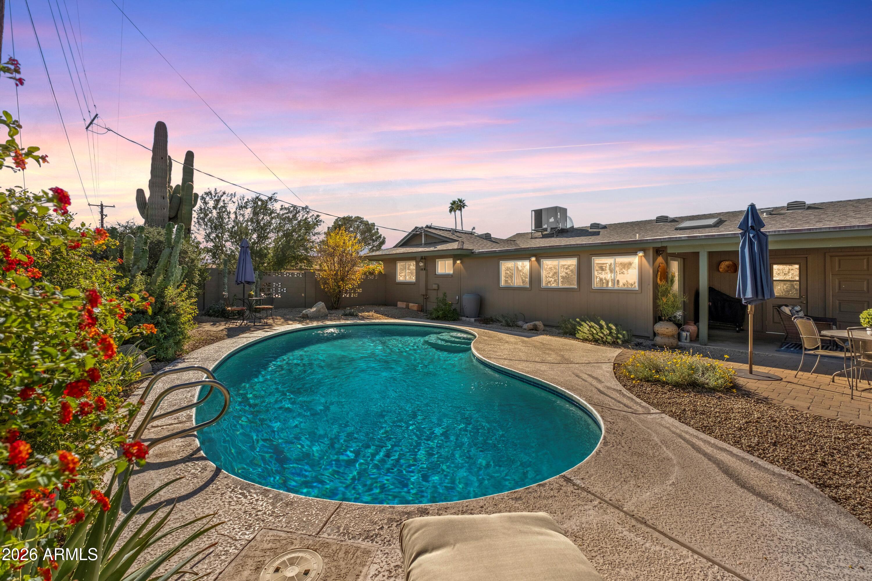 4901 North 82nd Street Scottsdale, AZ 85251 - Photo 30 of 48 a view of a swimming pool with a yard and wooden fence