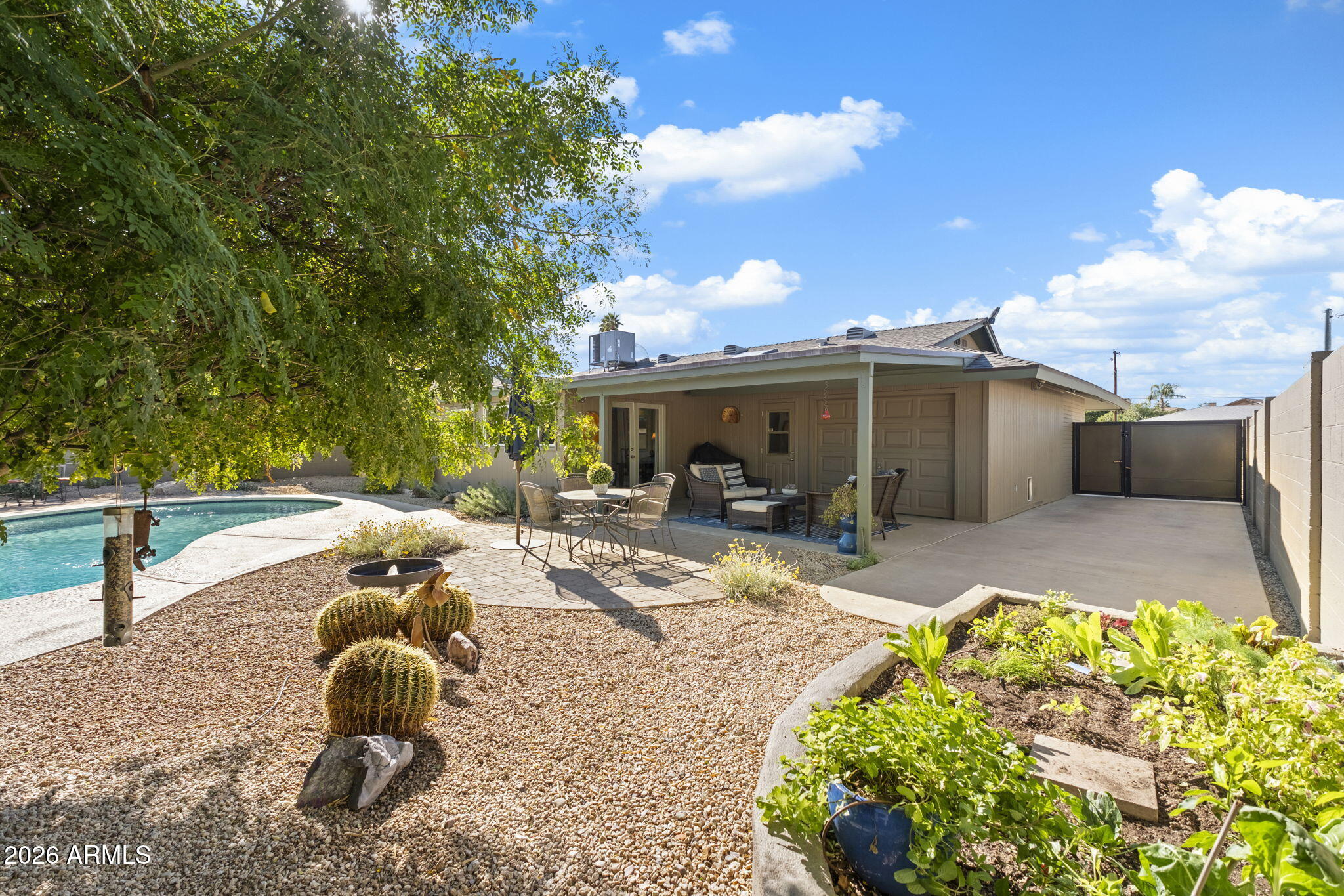 4901 North 82nd Street Scottsdale, AZ 85251 - Photo 35 of 48 a swimming pool with barbeque oven table and chairs