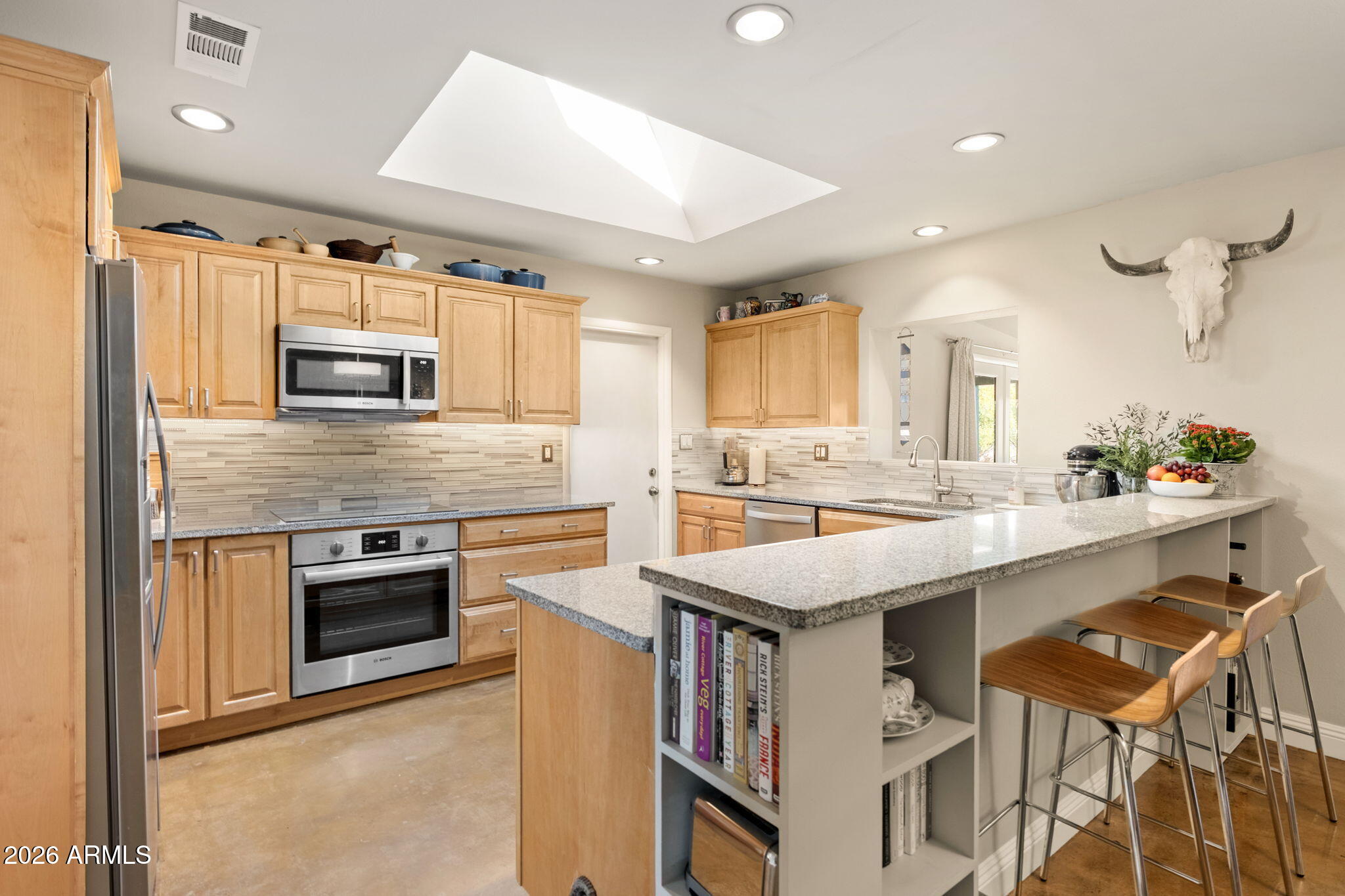 4901 North 82nd Street Scottsdale, AZ 85251 - Photo 4 of 48 a kitchen with kitchen island a stove a sink and a refrigerator