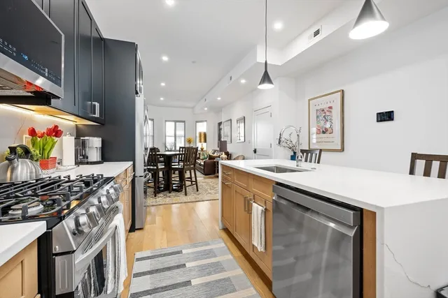 a kitchen with lots of counter top space and wooden floor