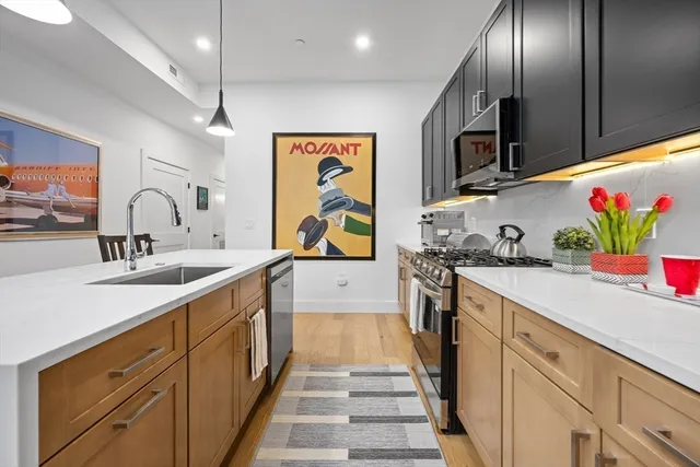 a kitchen with cabinets a sink and appliances