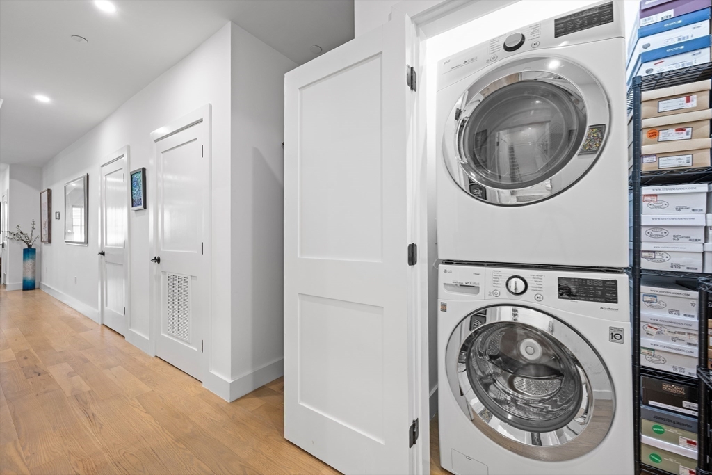 231 Everett Street, Unit 1 Boston, MA 02128 - Photo 20 of 39 a view of a hallway with washer and dryer