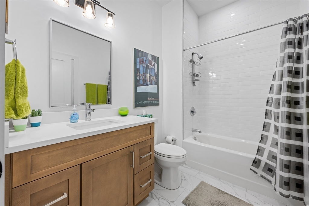 231 Everett Street, Unit 1 Boston, MA 02128 - Photo 21 of 39 a bathroom with a sink a toilet and shower