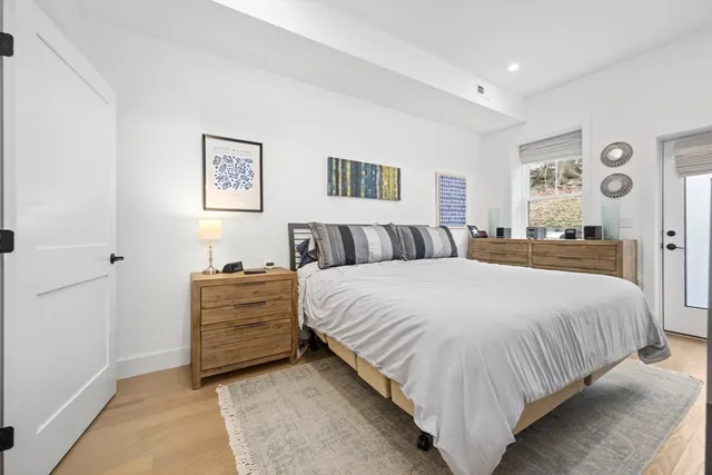 a bedroom with a bed and wall painting