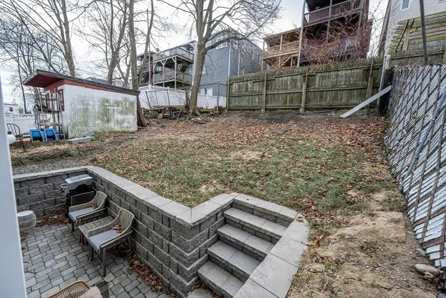 a view of a wooden house with a yard
