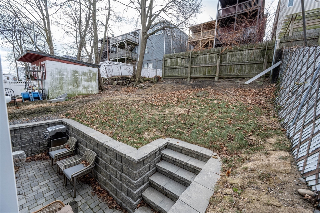 231 Everett Street, Unit 1 Boston, MA 02128 - Photo 30 of 39 a view of a wooden house with a yard