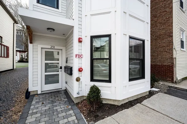 a front view of a house with white walls