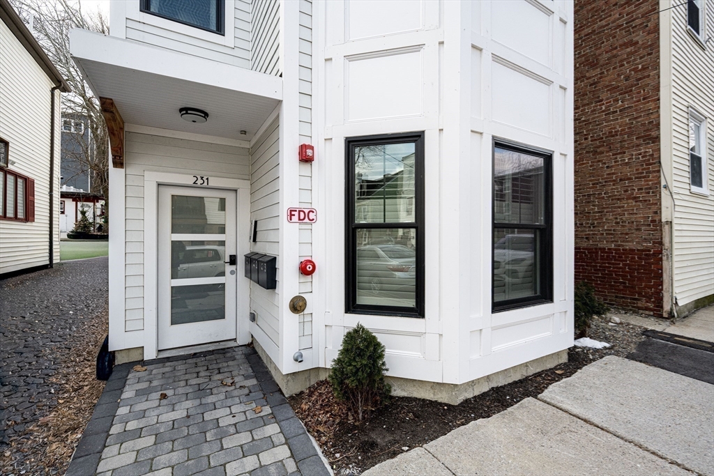 231 Everett Street, Unit 1 Boston, MA 02128 - Photo 5 of 39 a front view of a house with white walls