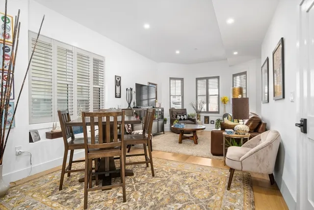 a dining room with furniture and wooden floor