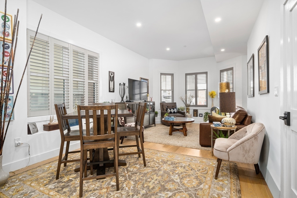 231 Everett Street, Unit 1 Boston, MA 02128 - Photo 6 of 39 a dining room with furniture and wooden floor
