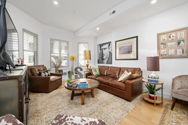 a living room with furniture a rug and a window