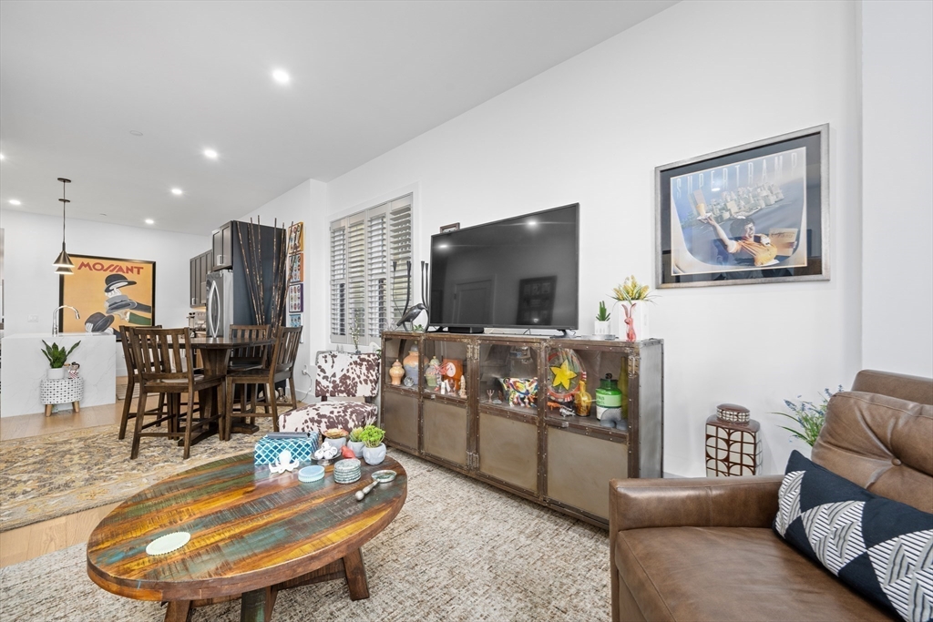 231 Everett Street, Unit 1 Boston, MA 02128 - Photo 10 of 39 a living room with furniture and a flat screen tv