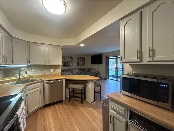 a kitchen with a refrigerator and a sink