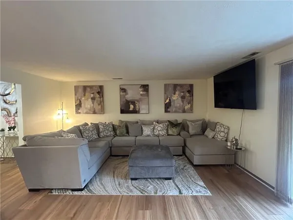 a living room with couches and a flat screen tv