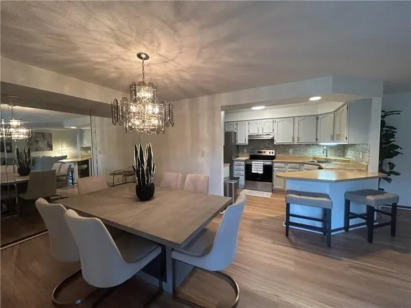 a view of a dining room with furniture wooden floor and chandelier