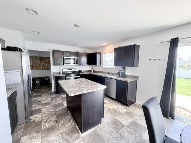 7480 Williams Street Merrillville, IN 46410 - Photo 19 of 49 a kitchen with stainless steel appliances granite countertop a stove top oven a sink a counter top space and cabinets