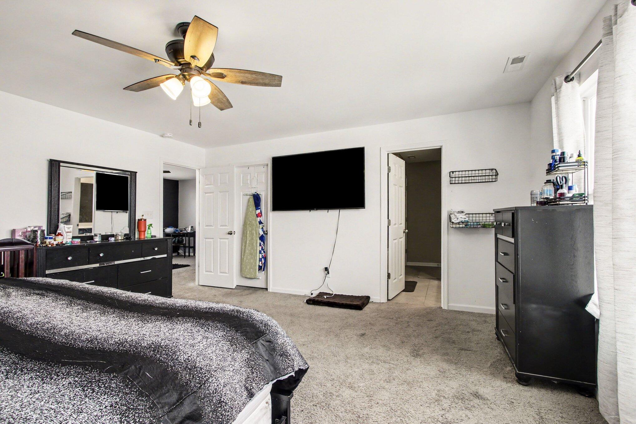 7480 Williams Street Merrillville, IN 46410 - Photo 29 of 49 a bedroom with a bed and a flat screen tv