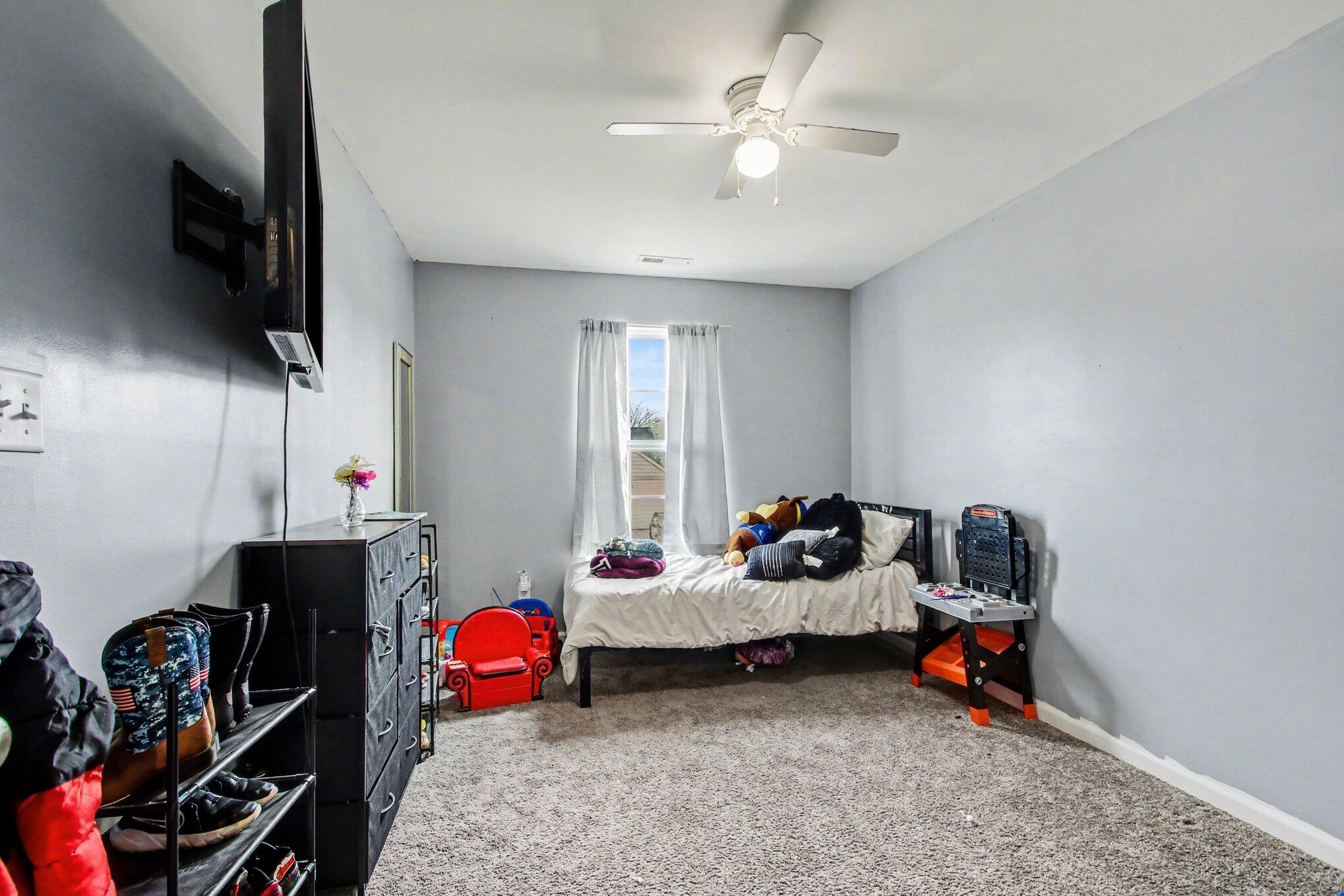 7480 Williams Street Merrillville, IN 46410 - Photo 34 of 49 a bedroom with furniture and a flat screen tv
