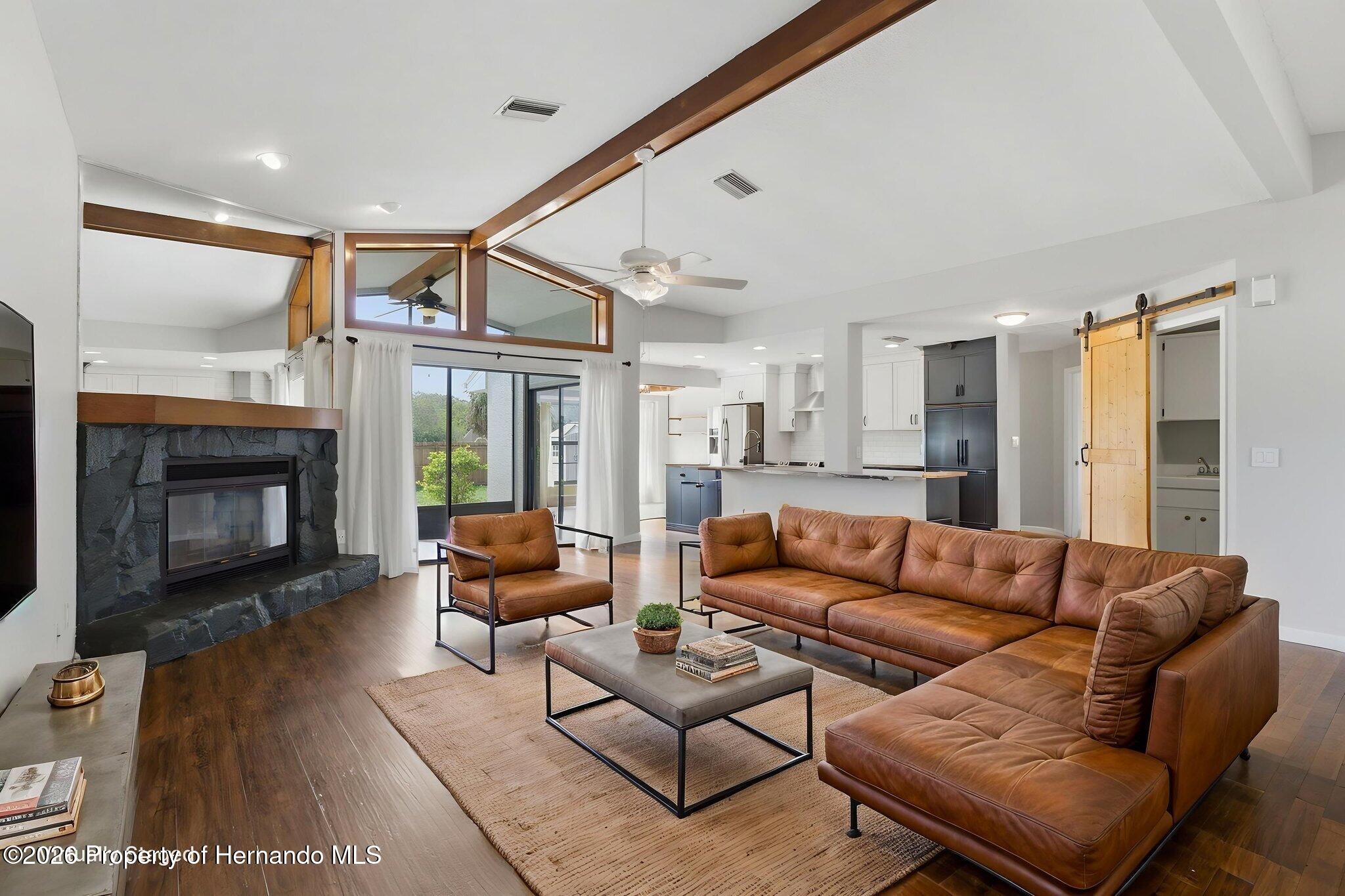 4966 Keysville Avenue Spring Hill, FL 34608 - Photo 11 of 50 a living room with furniture and a fireplace