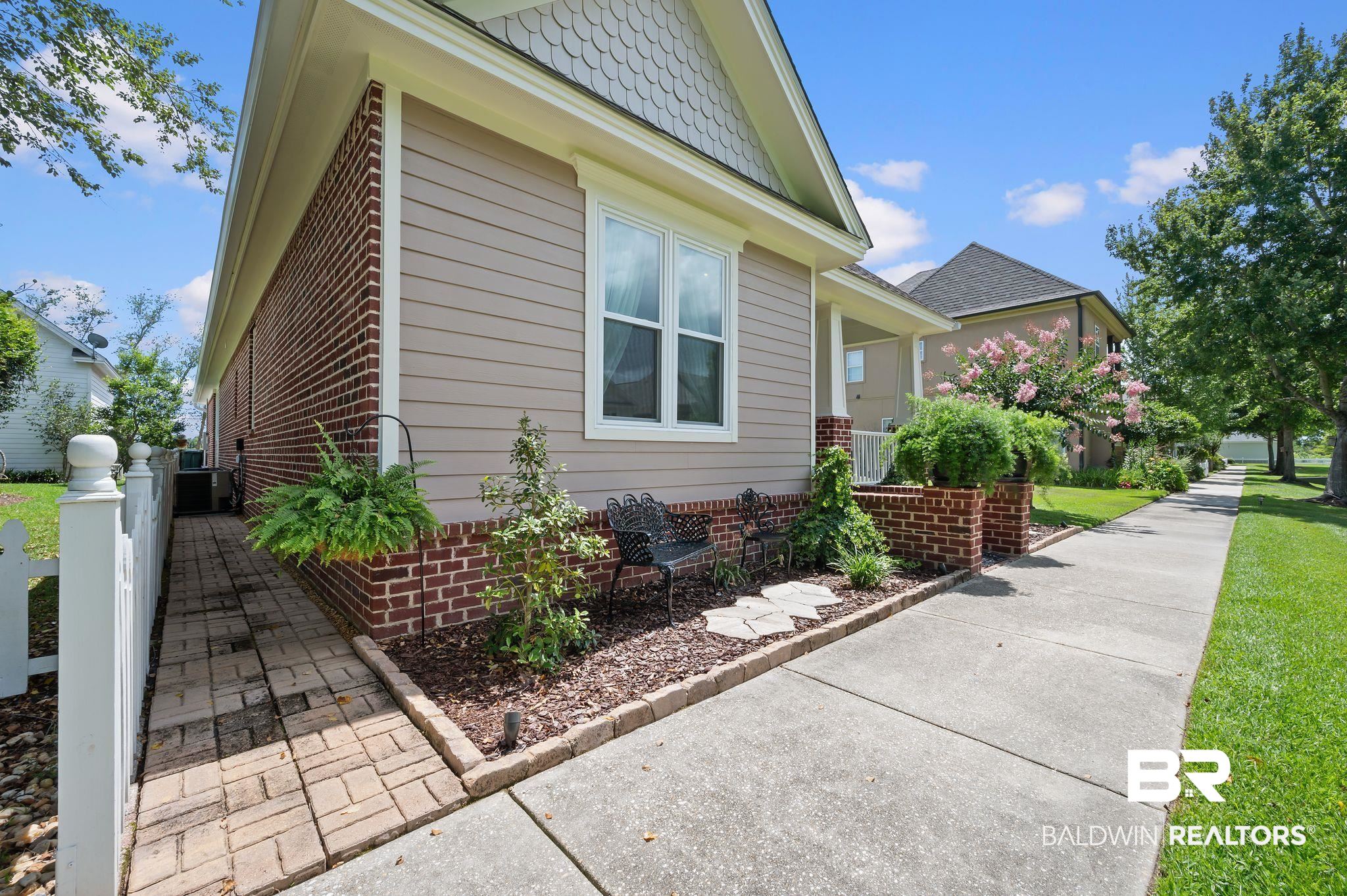 905 Buttercup Lane Foley, AL 36535 - Photo 5 of 47 View of home's exterior featuring brick siding and a central AC unit
