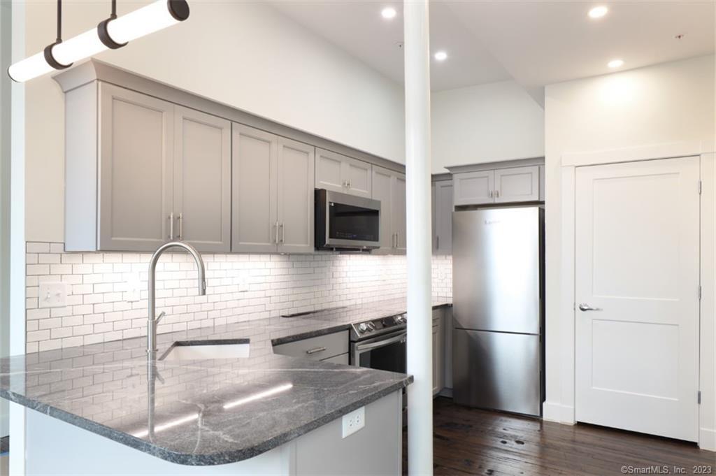 133 Bank Street, Unit 3H New London, CT 06320 - Photo 16 of 16 a kitchen with a refrigerator a sink and a stove top oven