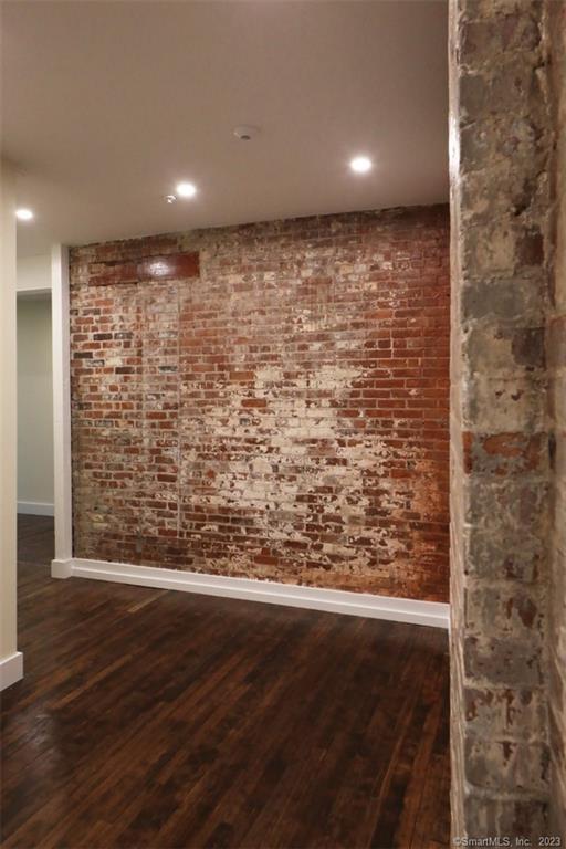 133 Bank Street, Unit 3H New London, CT 06320 - Photo 7 of 16 a view of a room with wooden floor and brick walls
