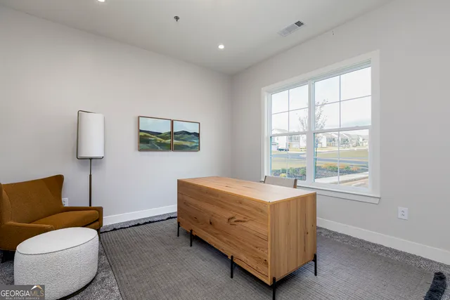 a bedroom with furniture and a window