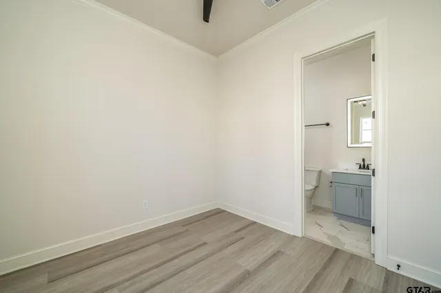 a view of a room with wooden floor and sink