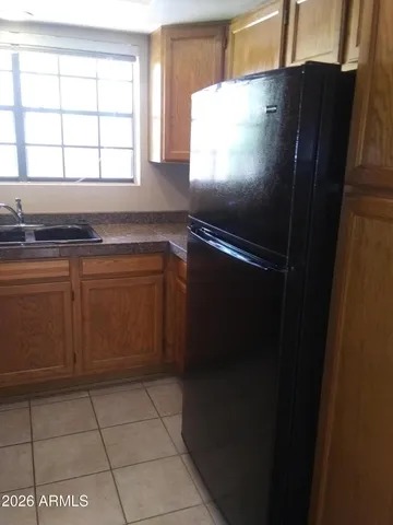 a kitchen with a refrigerator and window