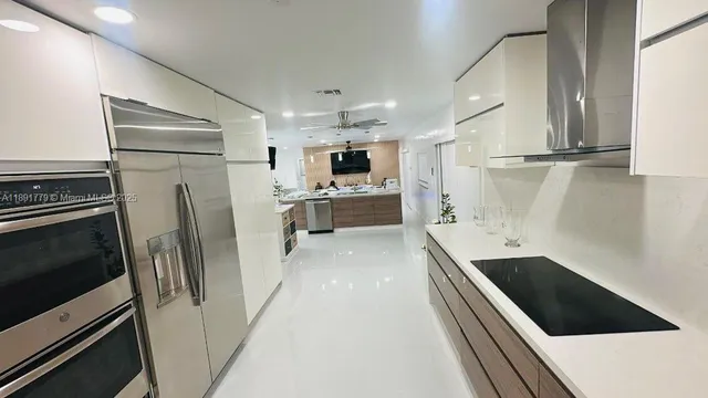 a kitchen with stainless steel appliances a refrigerator sink and microwave