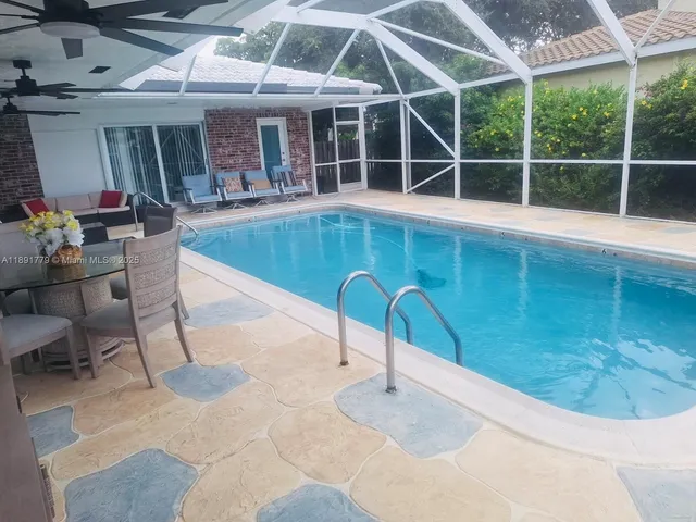 a swimming pool with outdoor seating